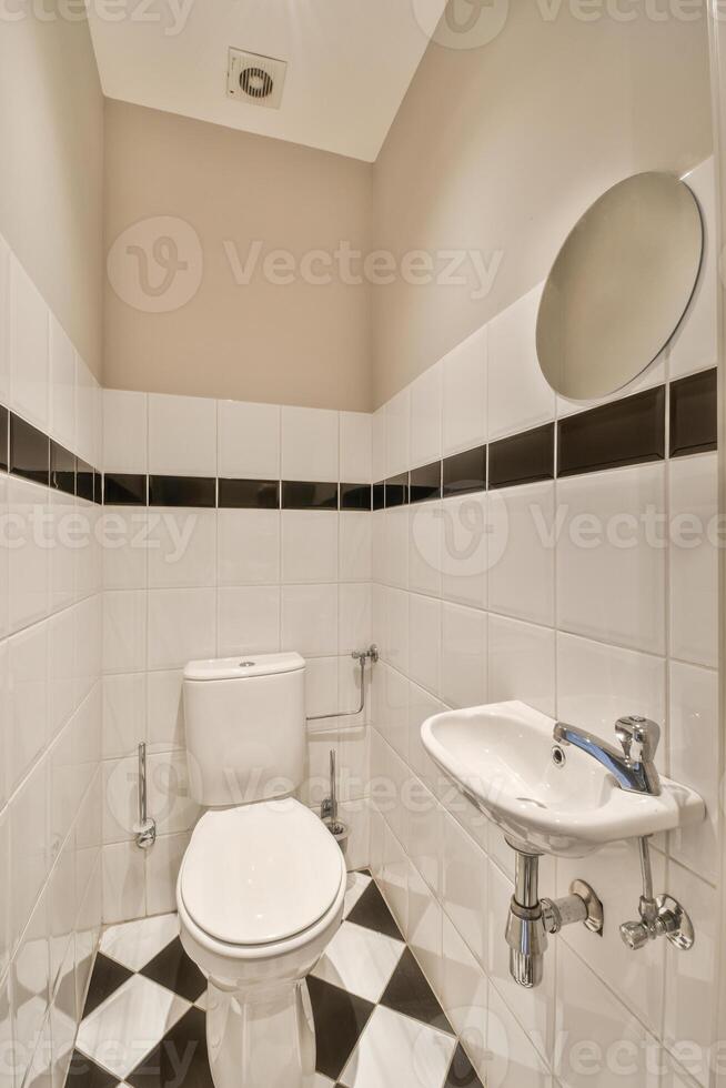 A white toilet in a bathroom photo