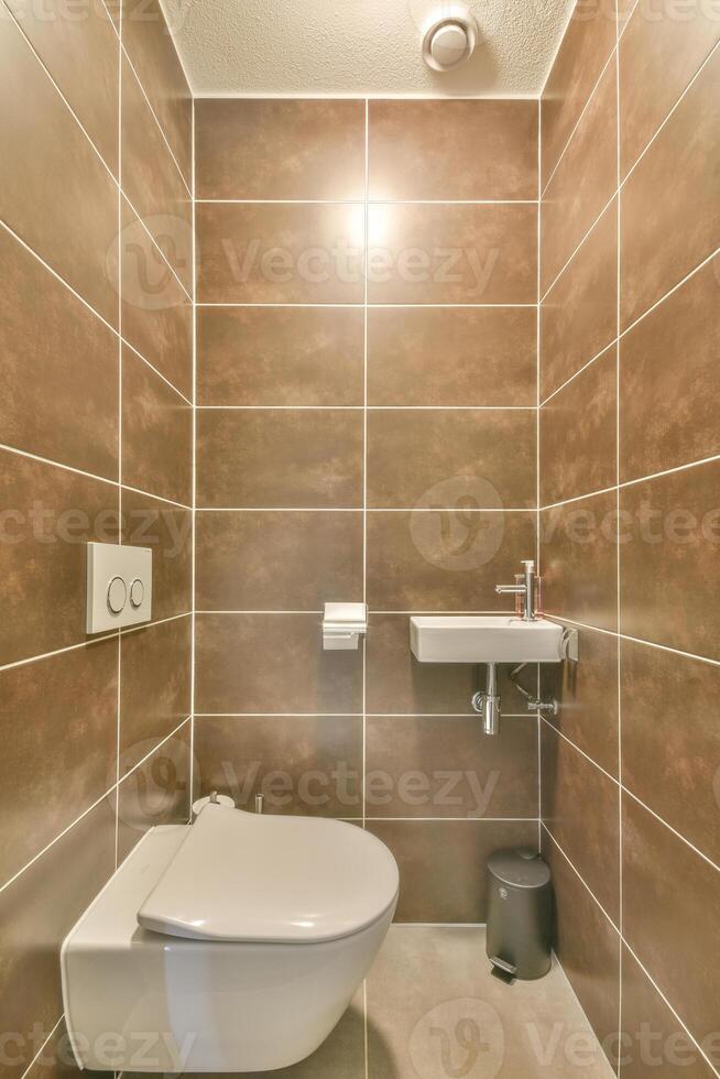 A bathroom with a toilet and a sink photo