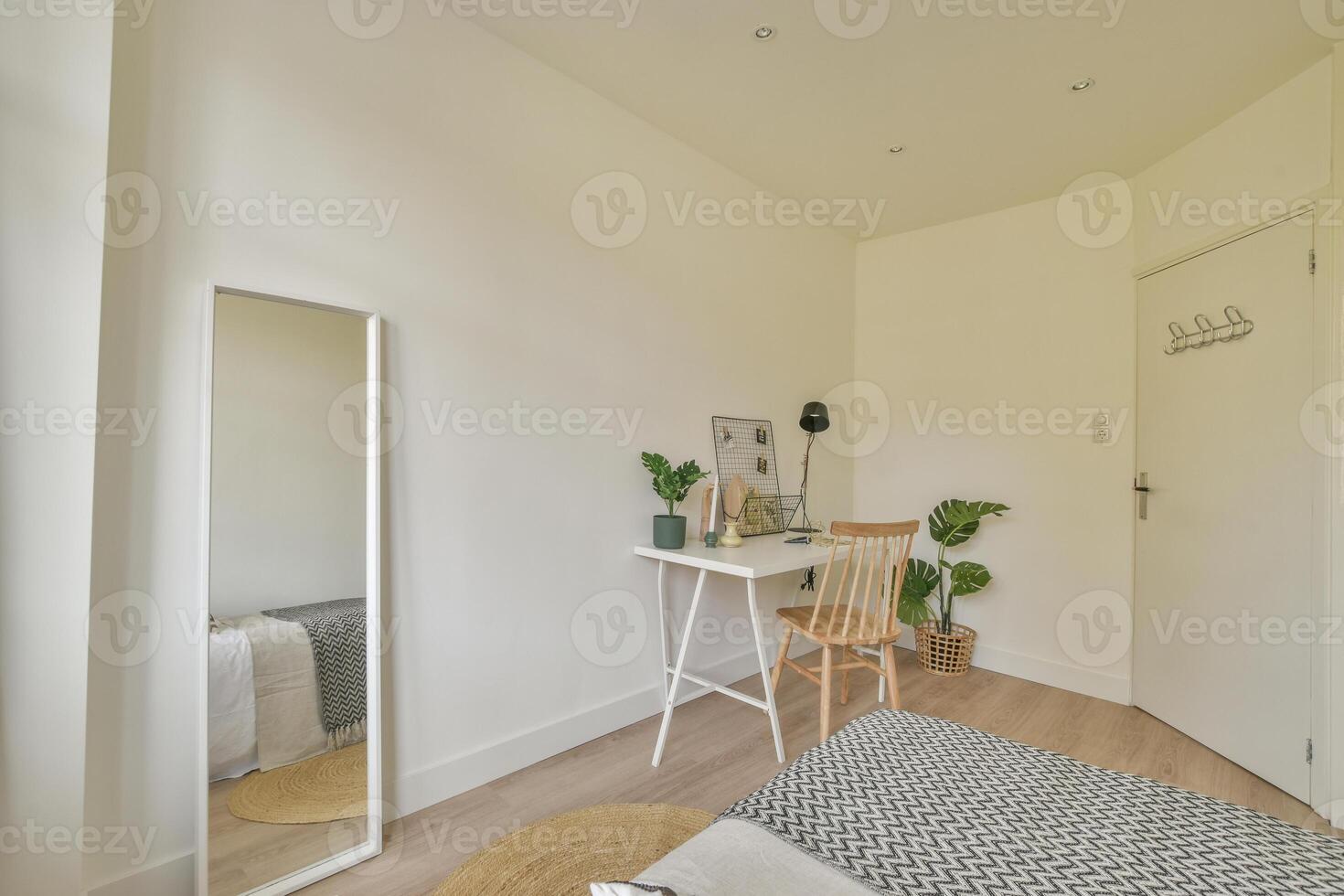 A bedroom with a desk, chair and mirror photo