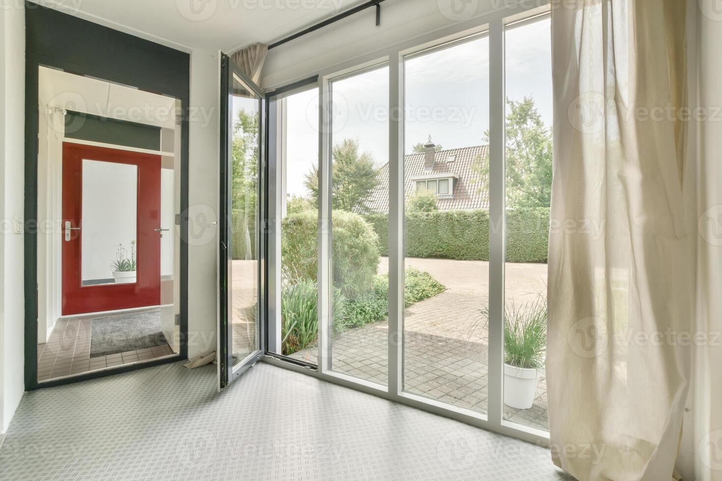 A large open door with a red door and a window photo