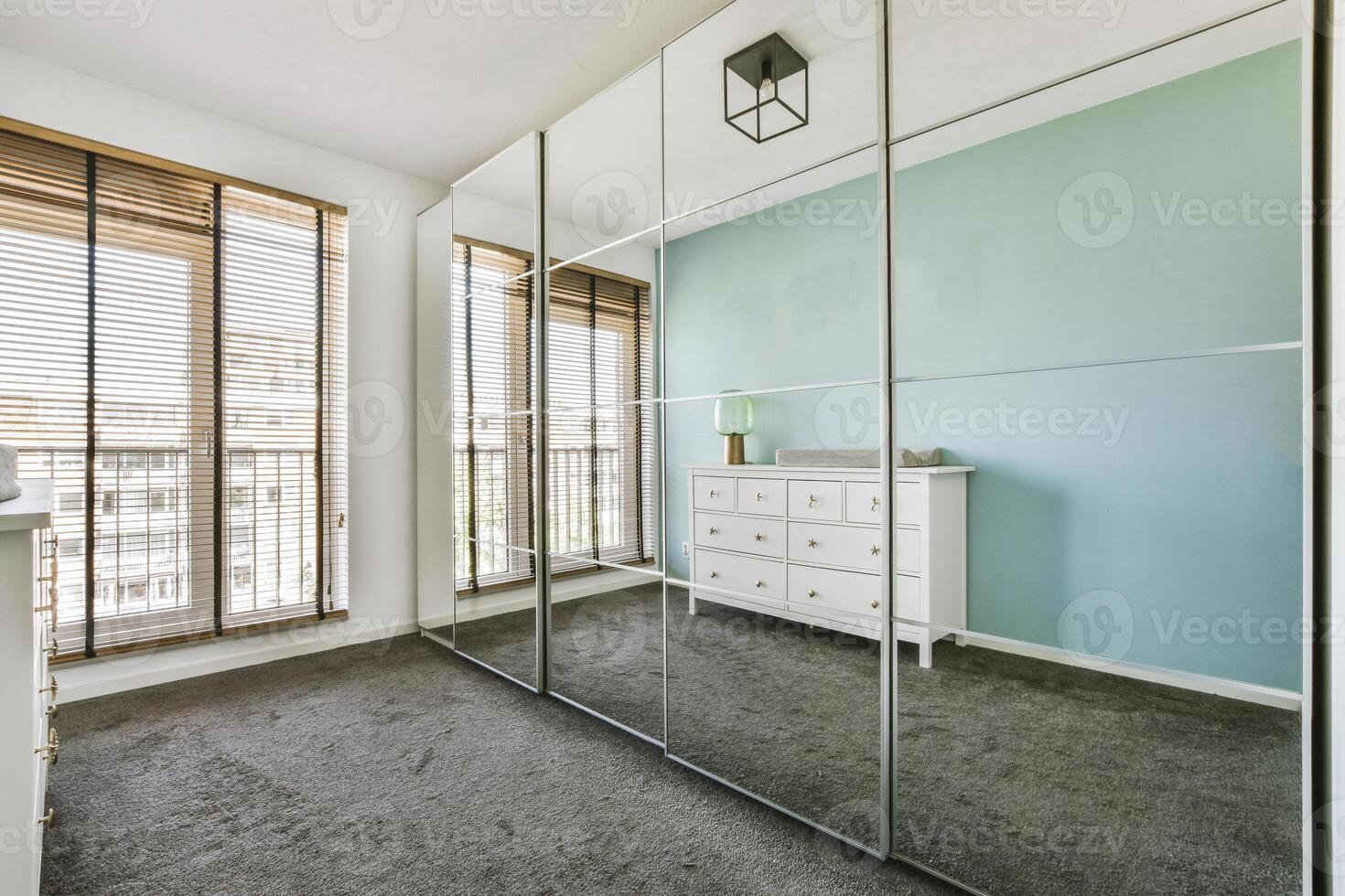 A bedroom with a mirror and a dresser photo