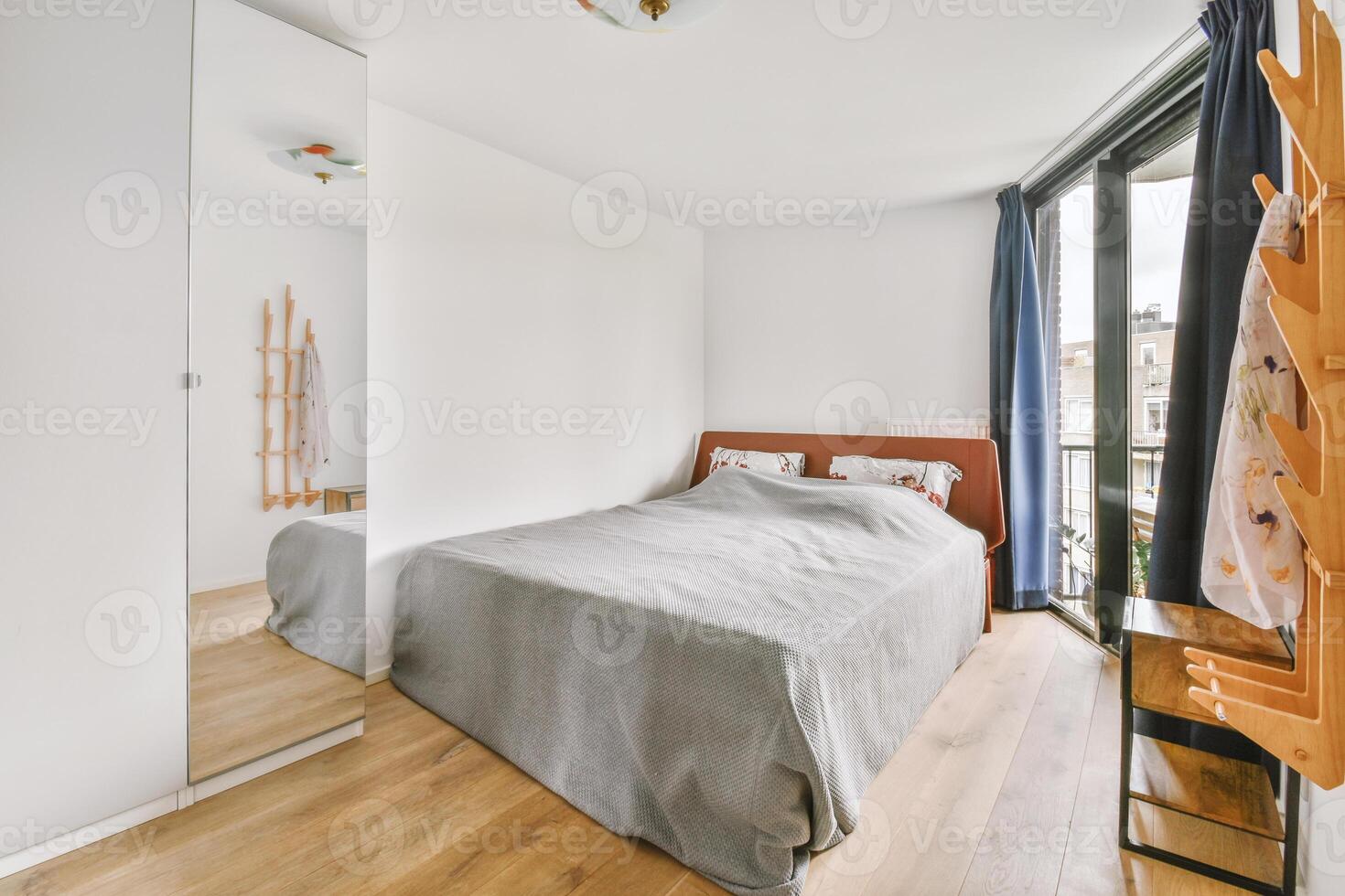 A bedroom with a bed and a wooden dresser photo