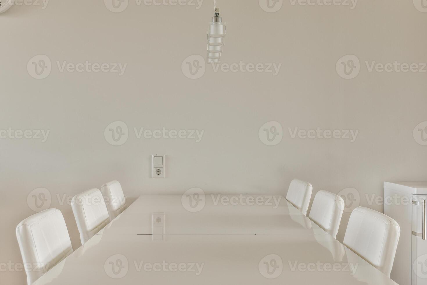 A white table with white chairs photo
