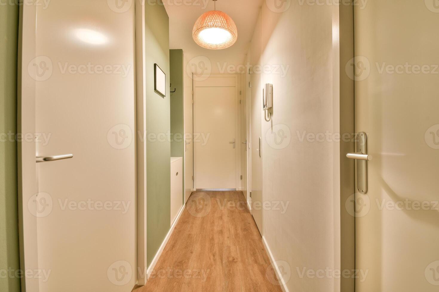 A hallway with a light hanging from the ceiling photo