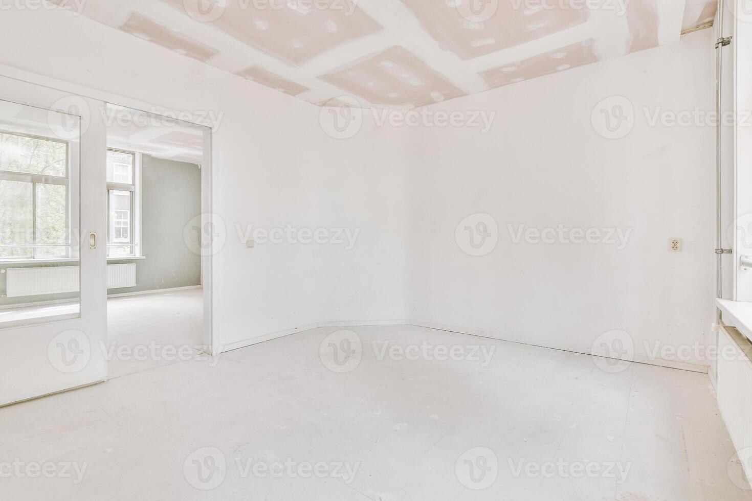 An empty room with white walls and a door photo