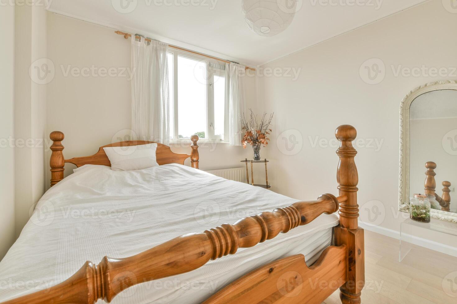A bedroom with a wooden bed and a mirror photo