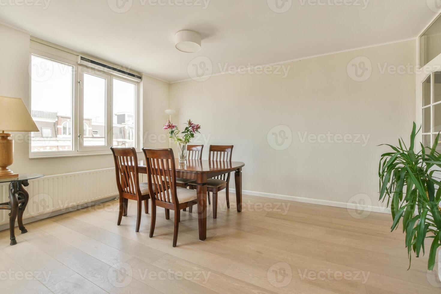 A dining room with a table and chairs photo