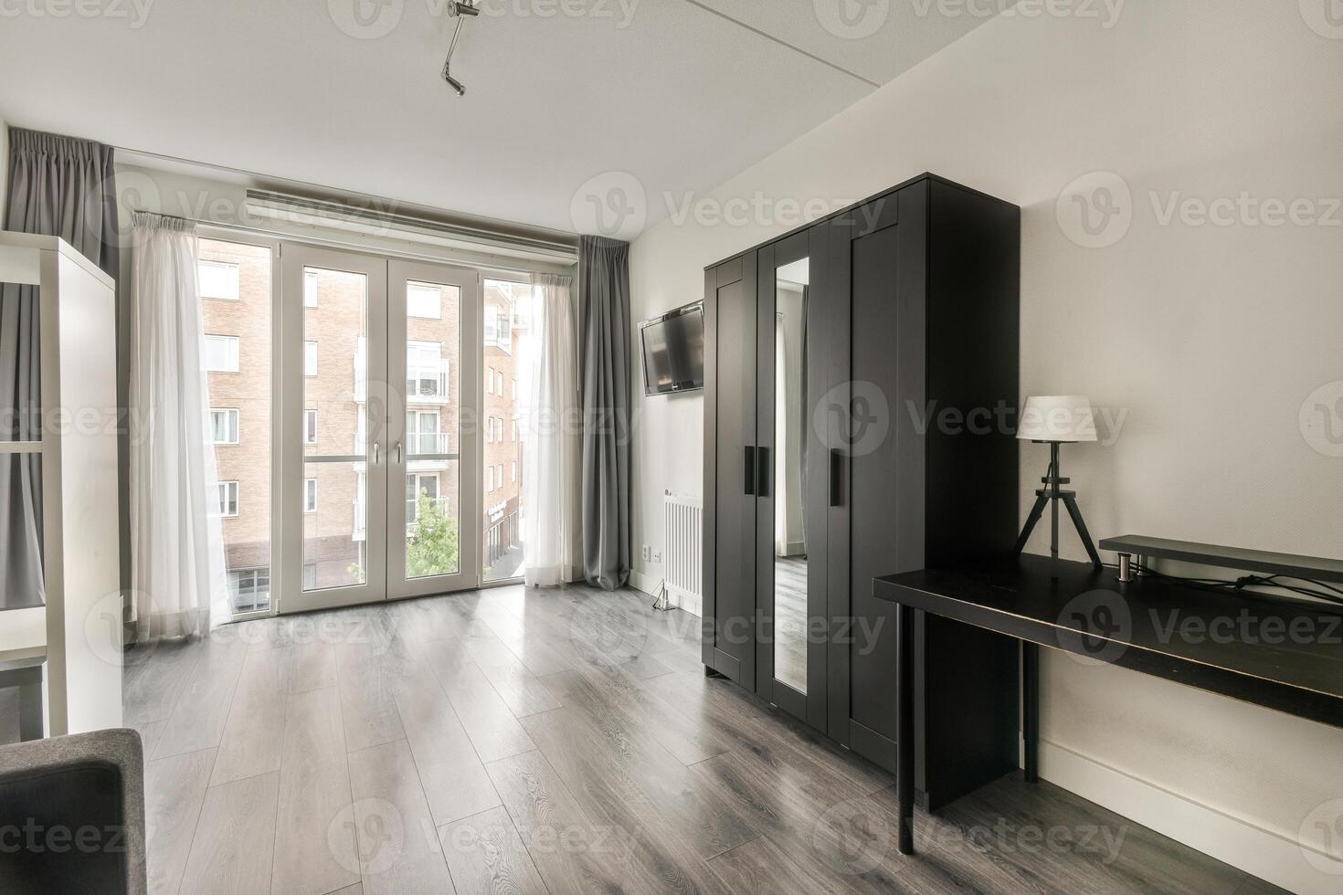 A room with a desk, chair and a door photo