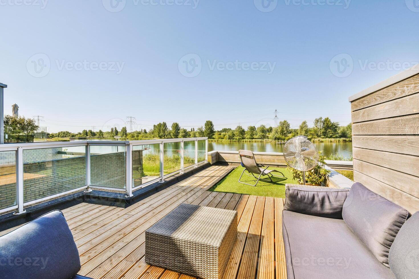 A wooden deck with a patio and a view of the water photo