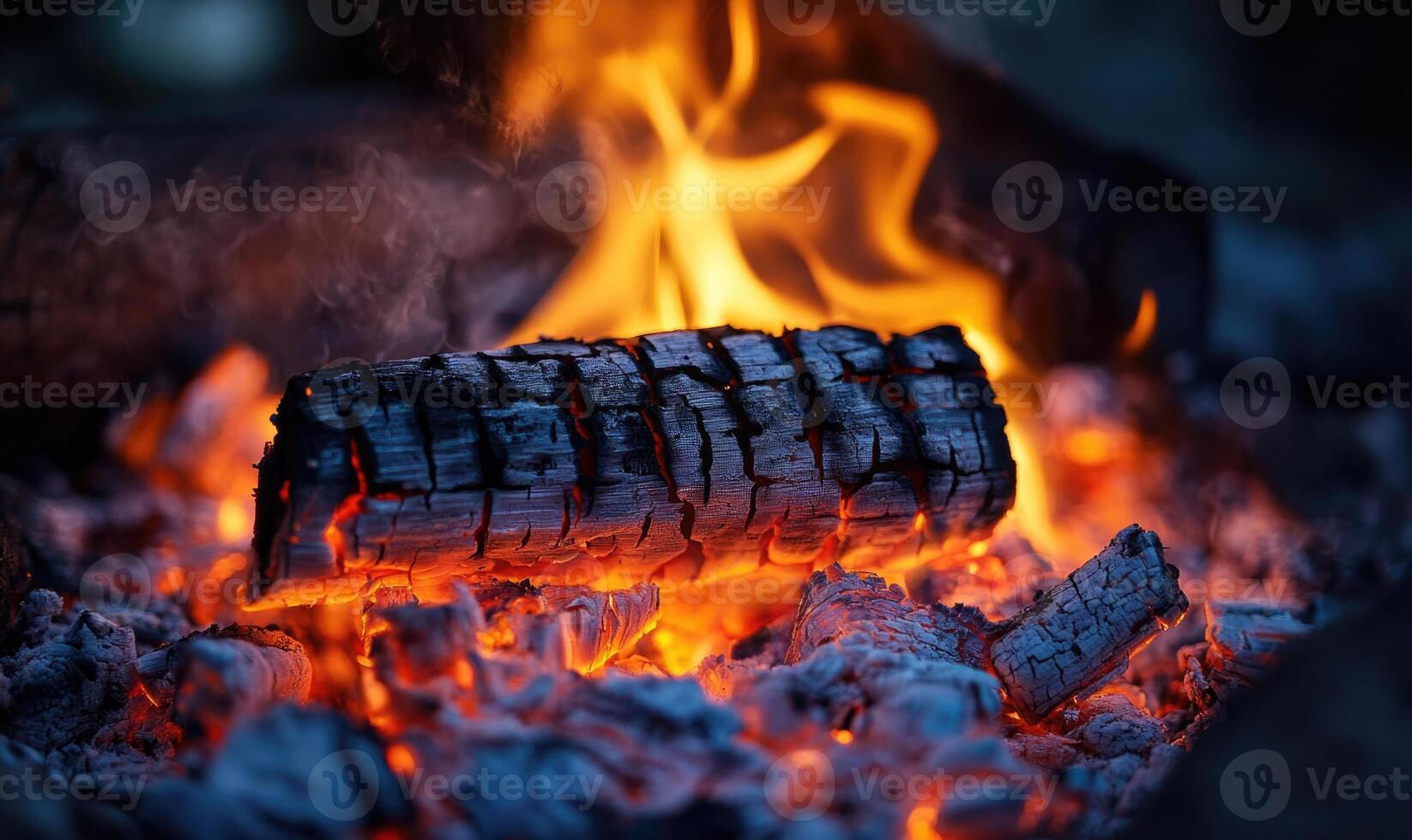 A brightly burning log closeup, flames flickering, glowing ash photo