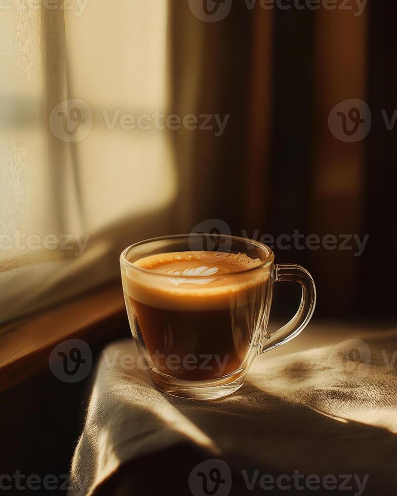 A glass cup of coffee, rich brown liquid with subtle foam photo