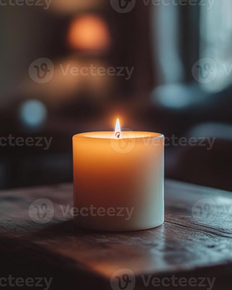 A thick white candle with a steady flame photo