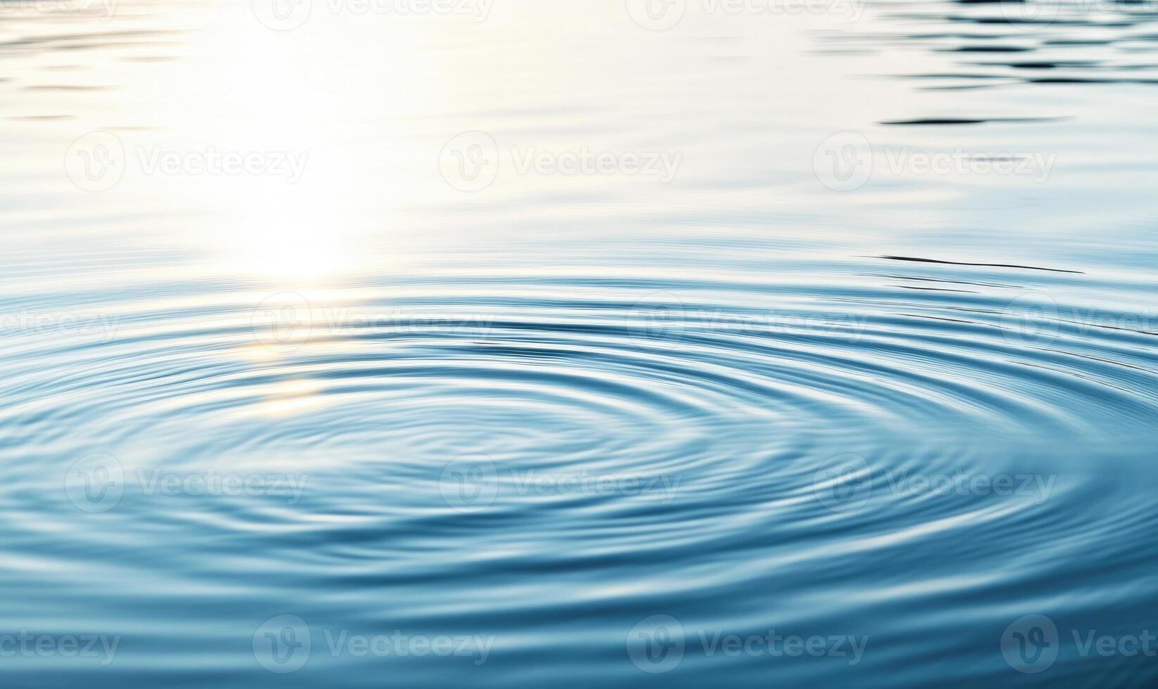 Close-up of ripples on a calm lake, sunlight glistening on the surface photo