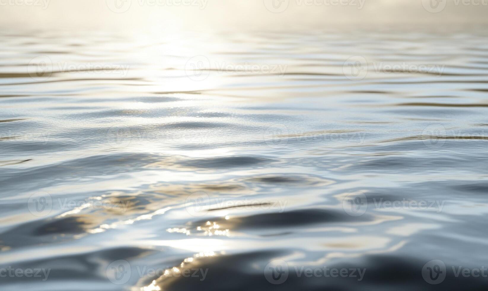 Calm lake surface with subtle waves, sunlight casting shimmering reflections photo