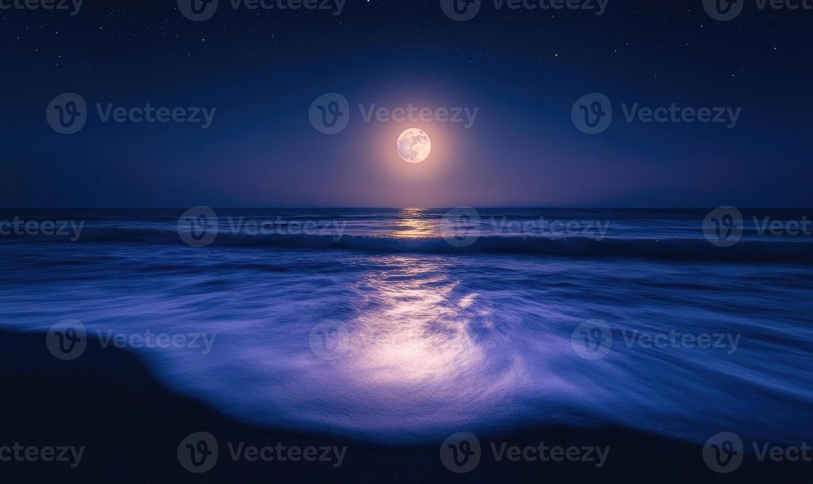Bright moon casting a long reflection on the ocean photo