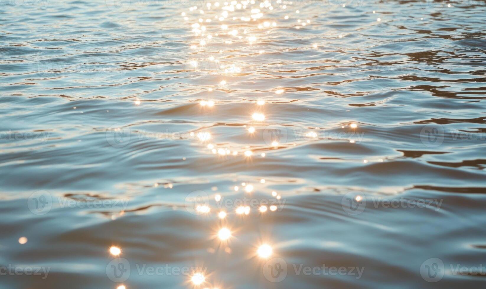 Close-up of small waves in a lake, sunlight sparkling on the water photo