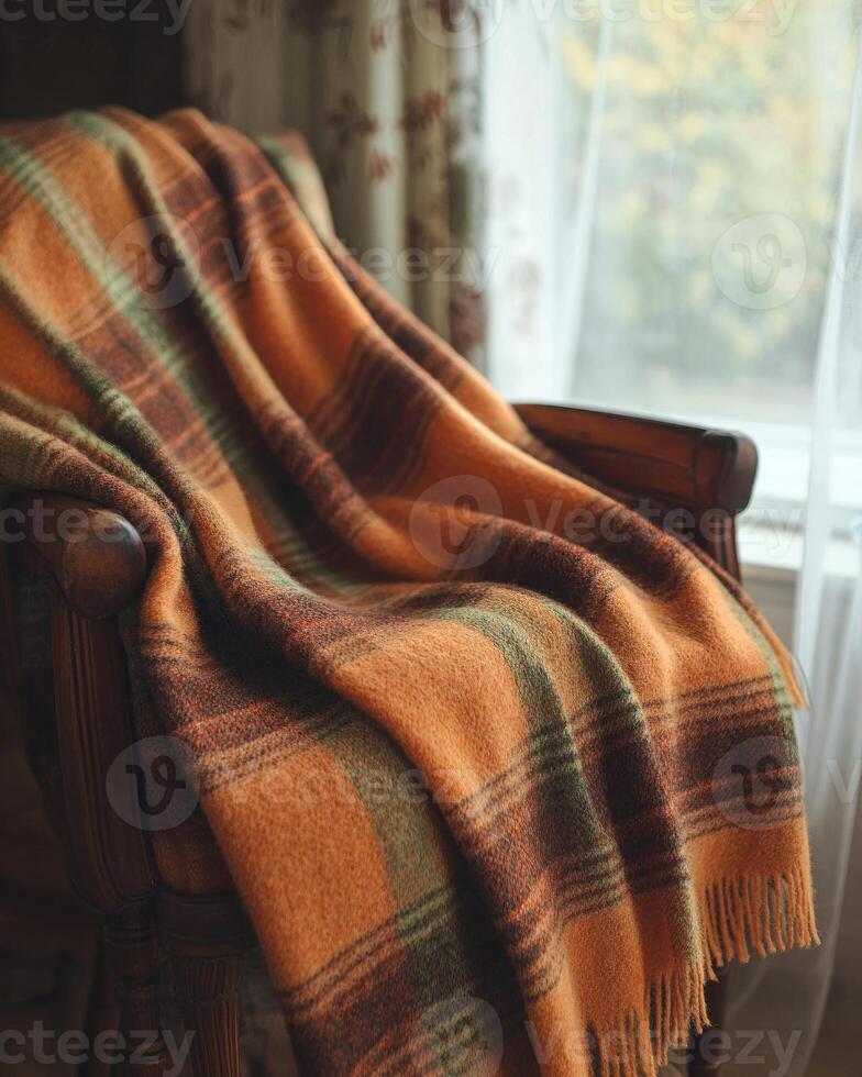 Cozy autumn blanket, plaid pattern, soft wool texture, draped over a chair photo