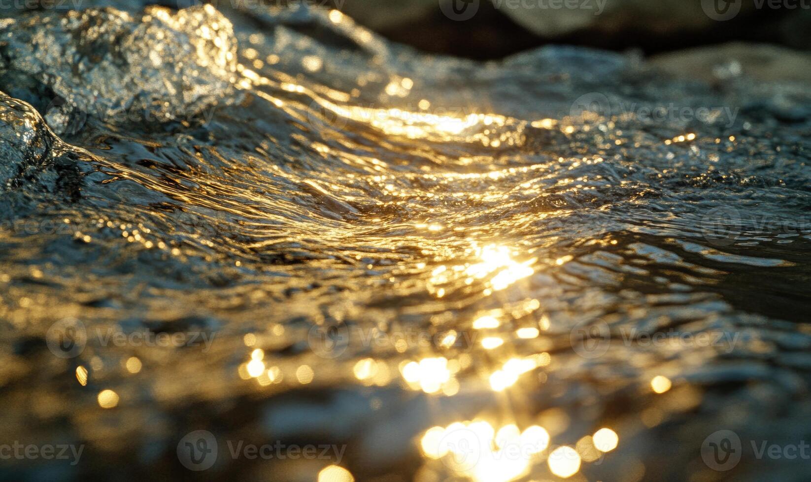 Close-up of a flowing river, sunlight reflecting on the water photo