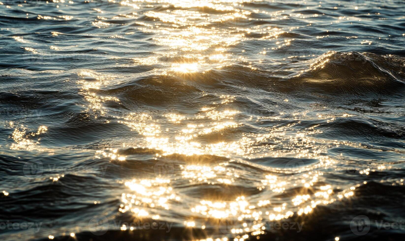 Close-up of small waves in a lake, sunlight sparkling on the water photo