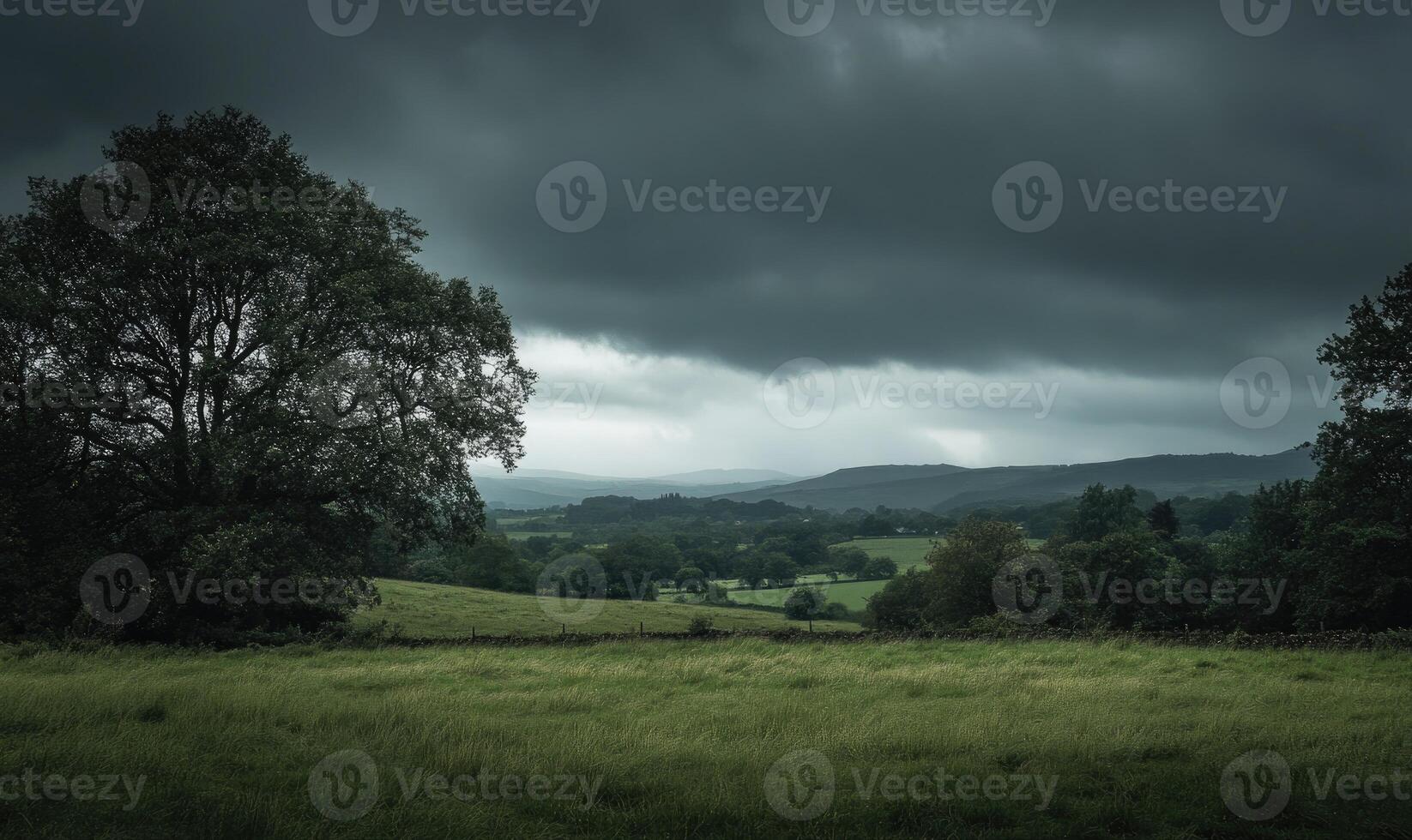 Dark, overcast sky looming above a quiet countryside photo