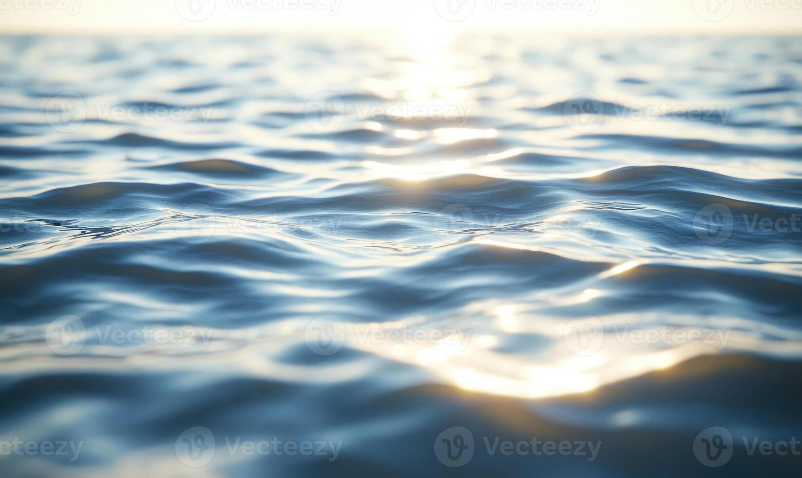 Ocean surface with gentle waves, sunlight sparkling on the water photo