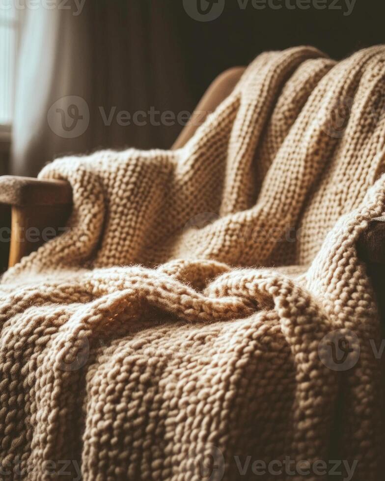 Knitted fall blanket, cozy and inviting, draped over a chair photo