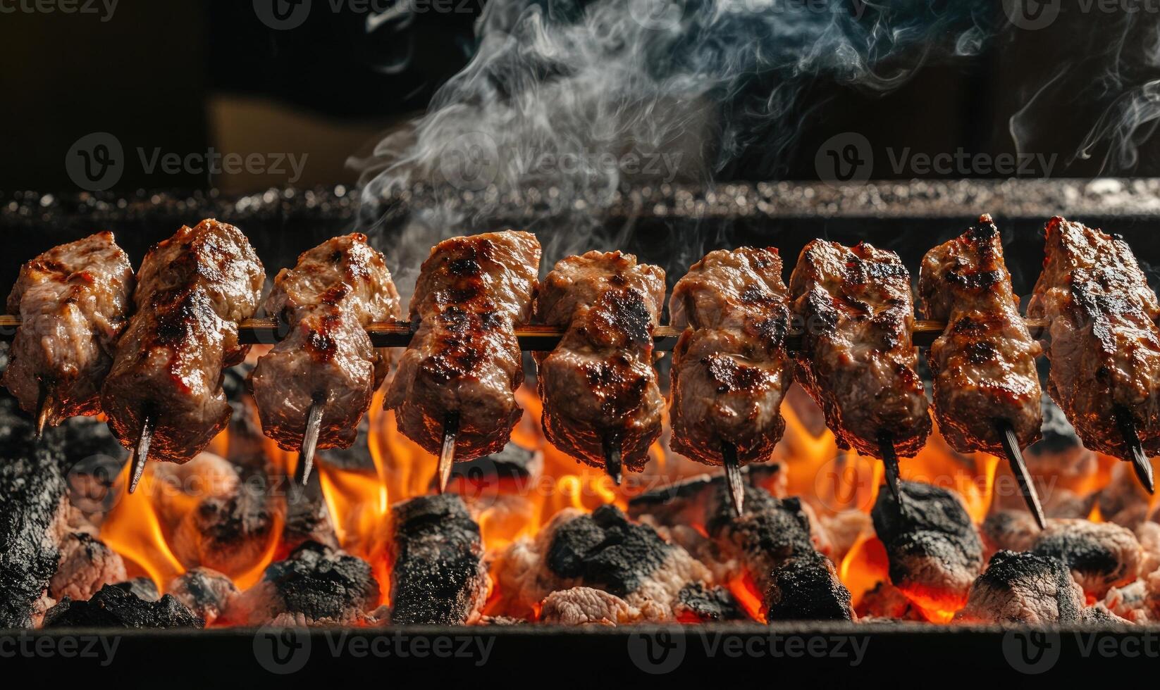 Meat rotating over glowing embers photo