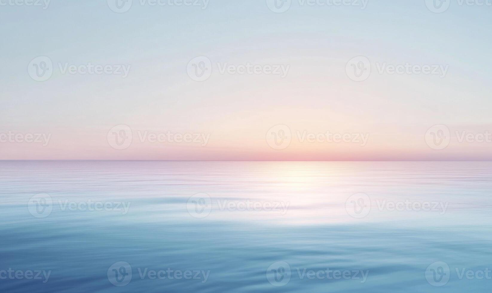 A calm ocean with a pink and orange sky in the background photo