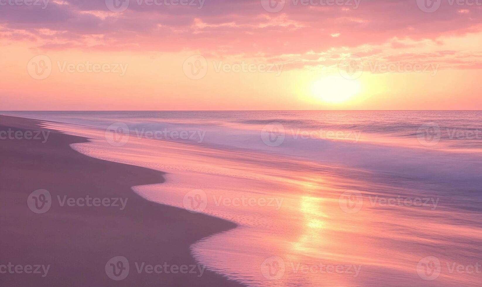 A beautiful beach with a pink and orange sunset in the background photo