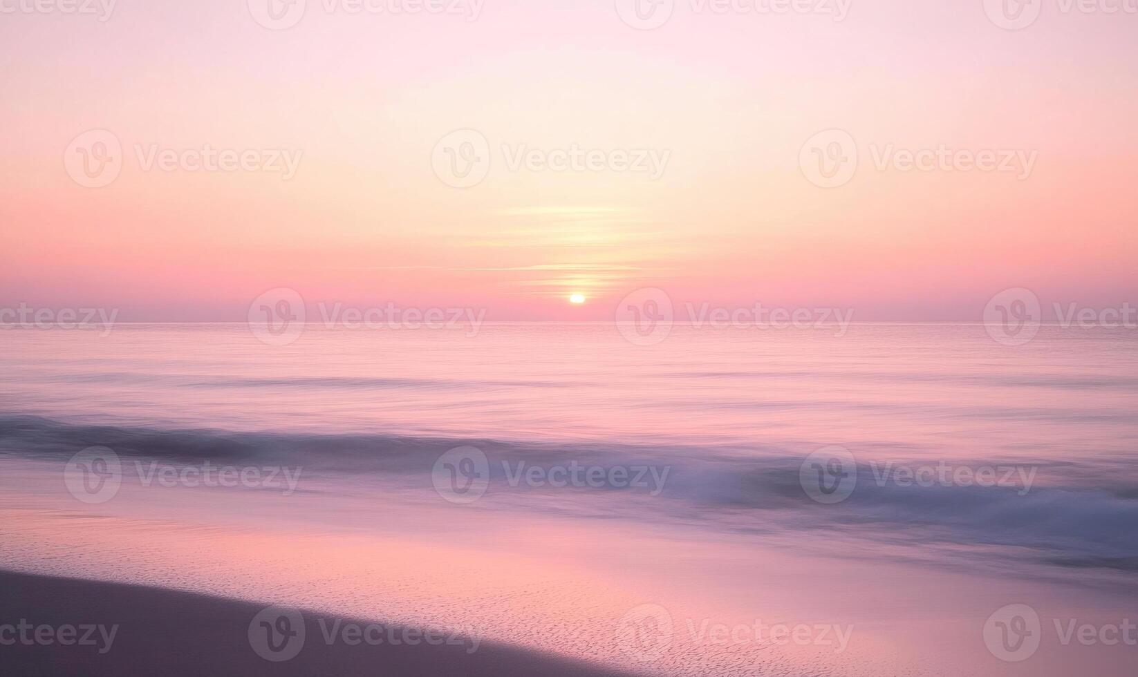 A beautiful beach with a pink and orange sunset in the background photo