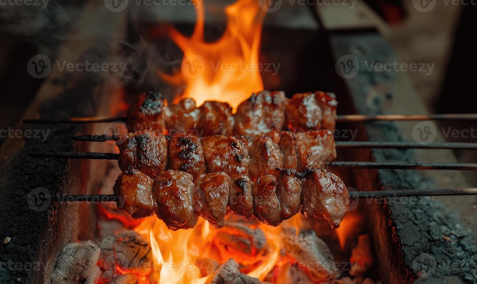Skewers of mixed meat and vegetables on a grill photo