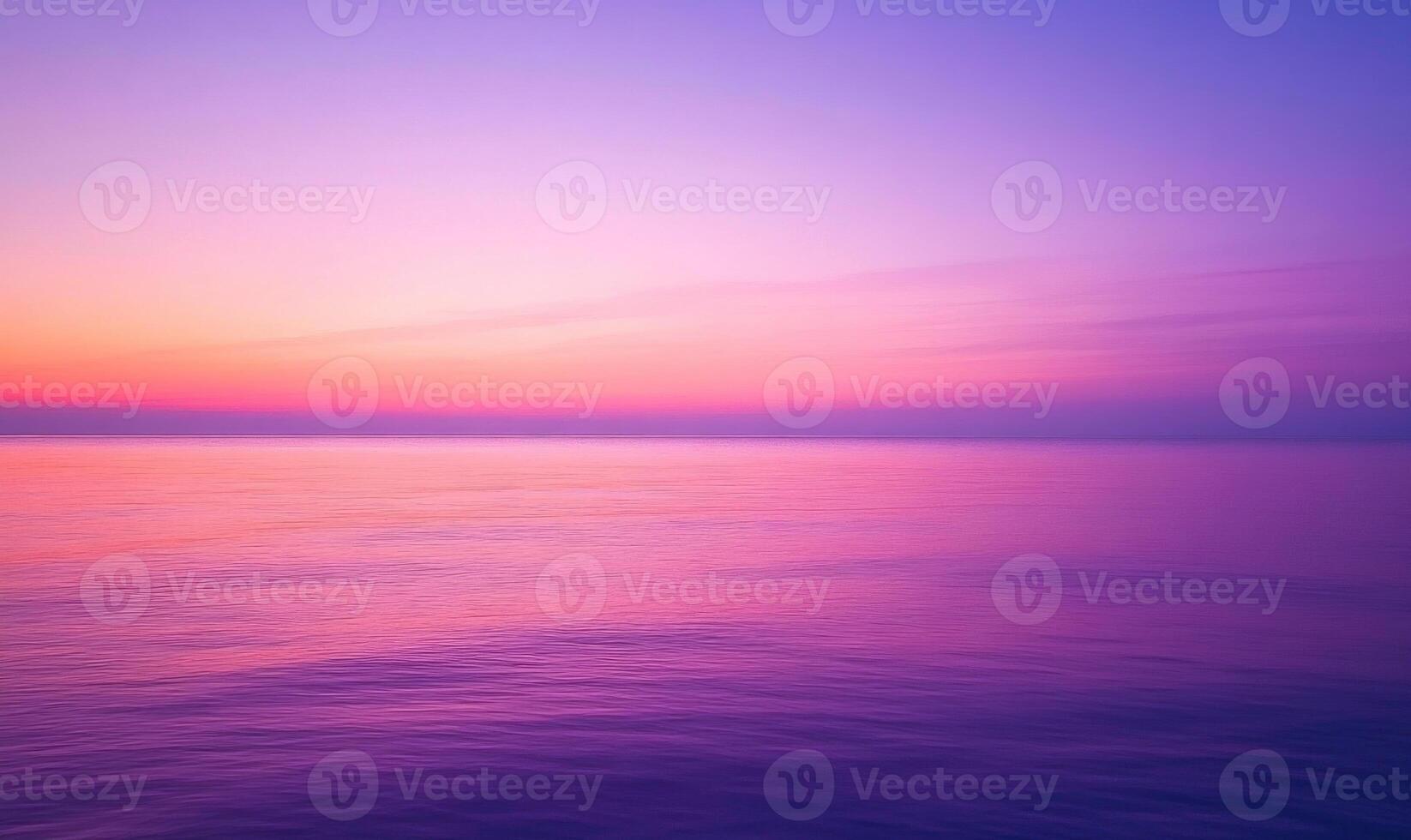 Soft purple and pink sunset, distant horizon blending with the colorful sky photo
