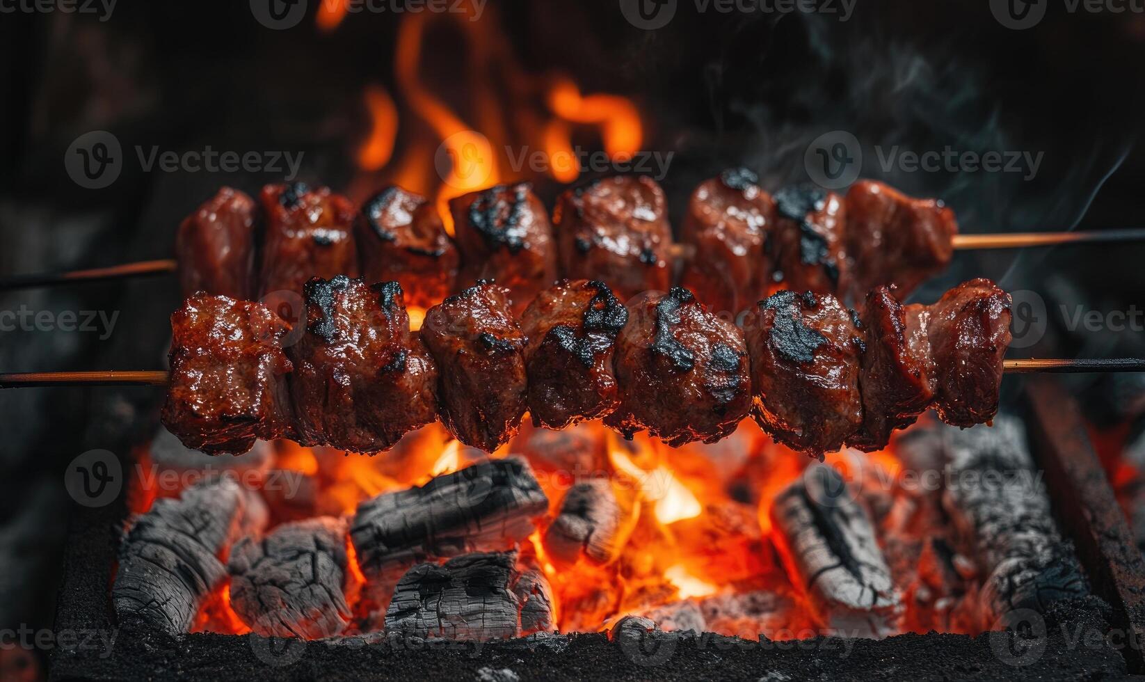 Skewers of mixed meat and vegetables on a grill photo