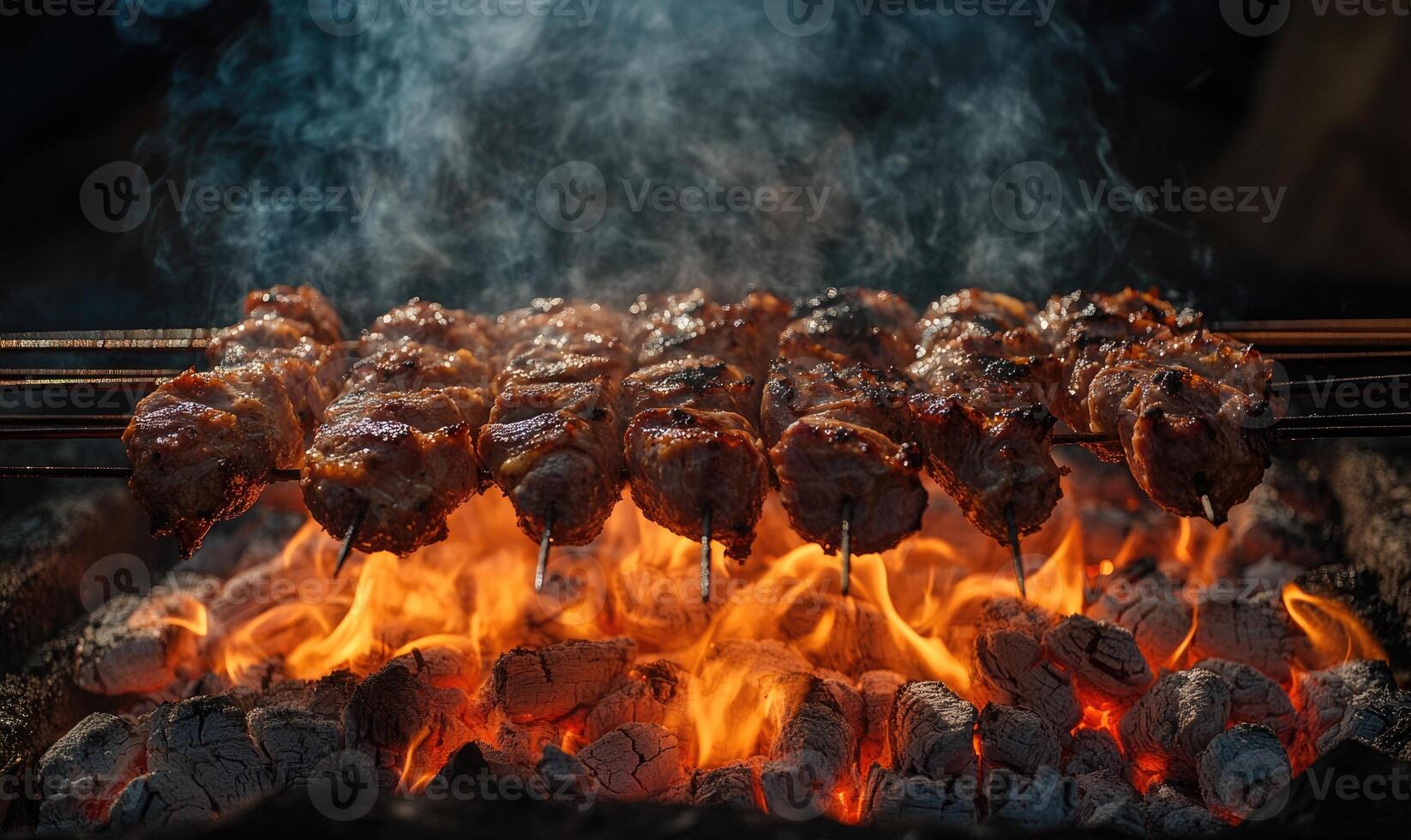 Skewers of mixed meat and vegetables on a grill photo
