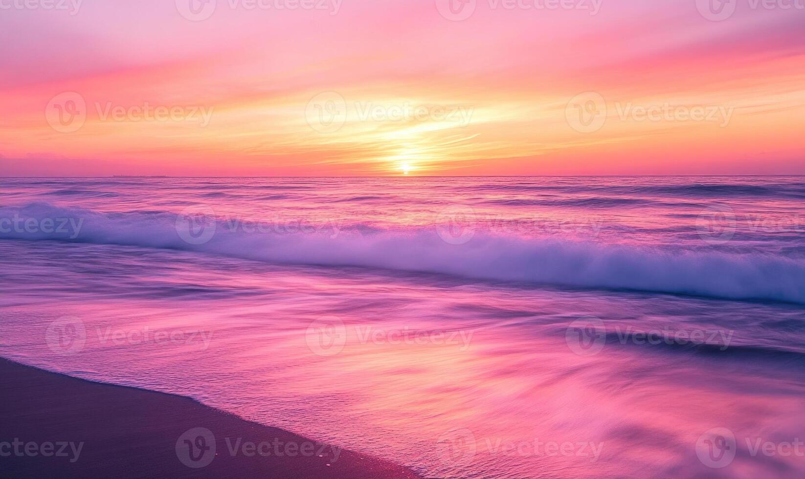 A beautiful beach with a pink and orange sunset in the background photo
