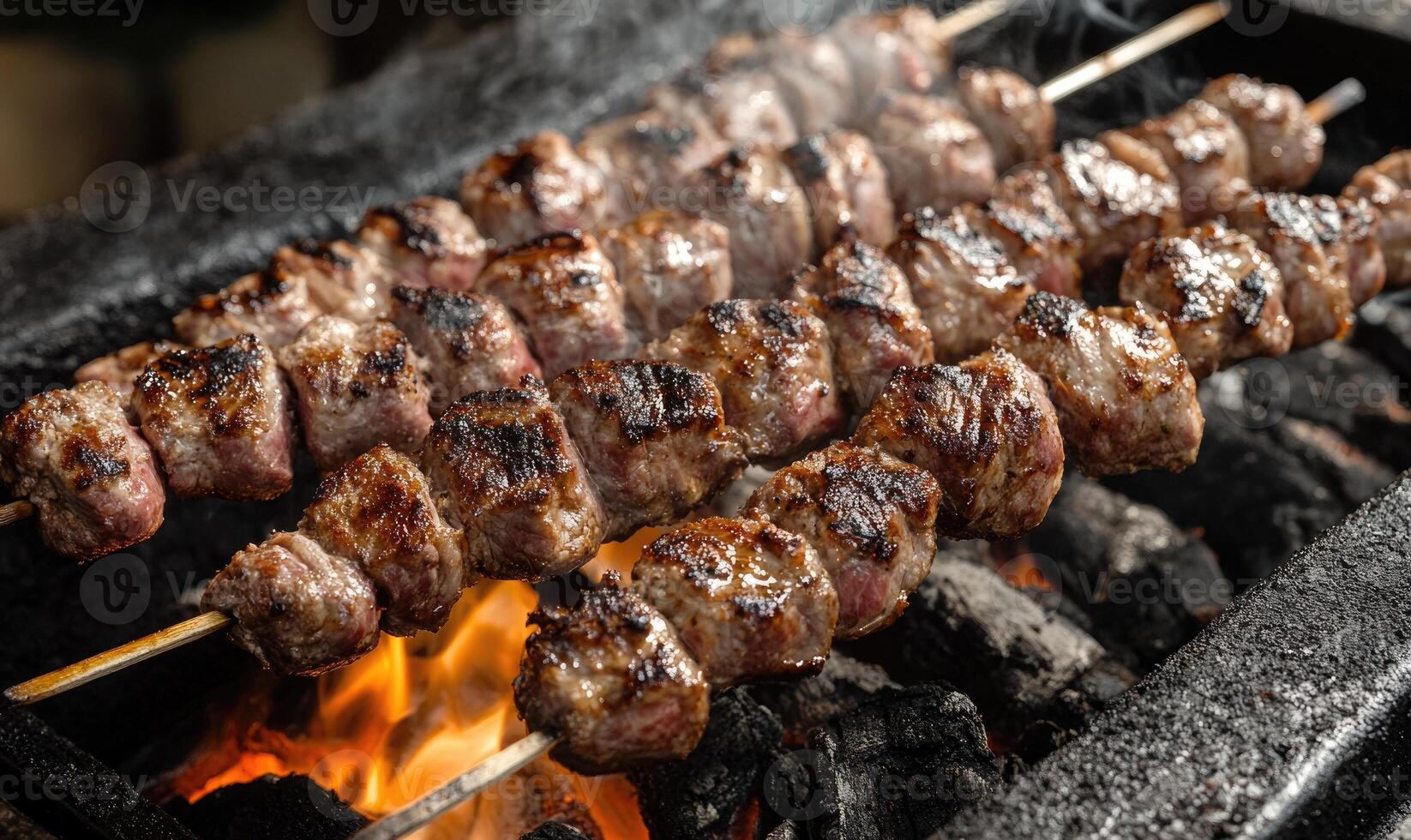 Meat rotating over glowing embers photo