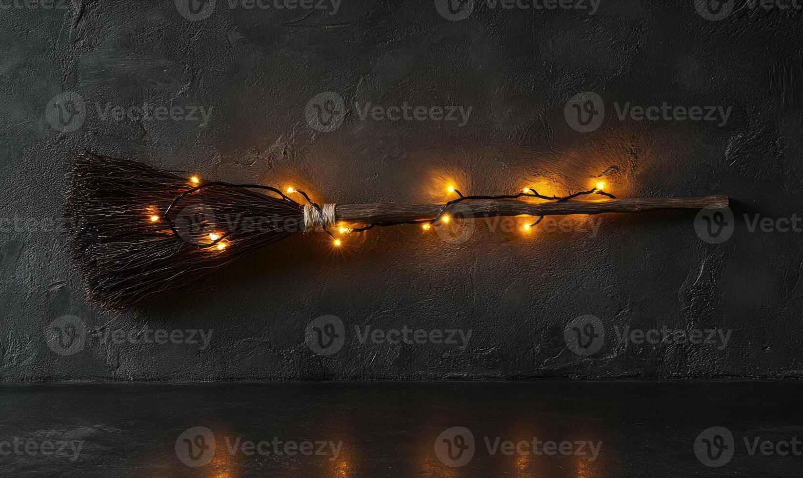 Witch's broom adorned with glowing garlands photo