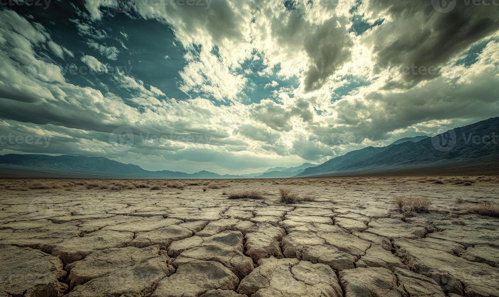 Thick clouds rolling across the sky, casting shadows over a rocky desert landscape photo