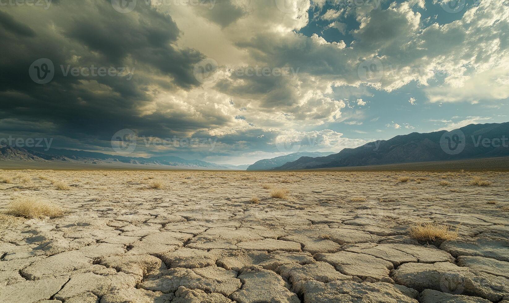 Thick clouds rolling across the sky, casting shadows over a rocky desert landscape photo