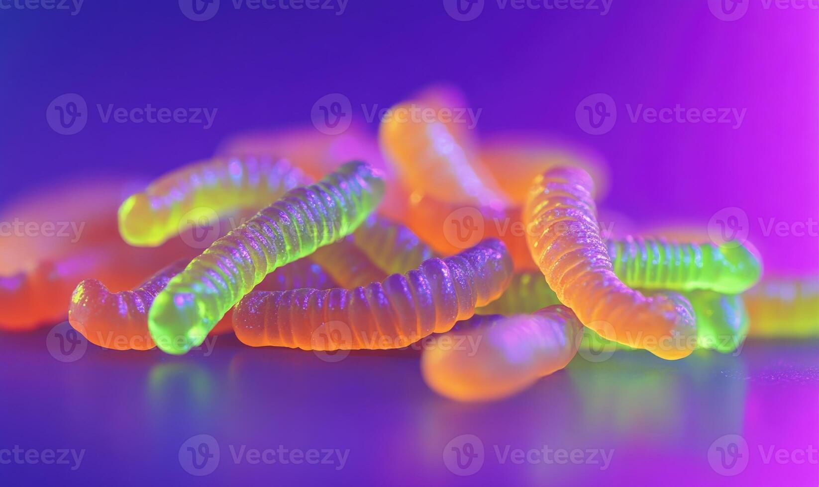 Pile of Halloween gummy worms in neon green and orange photo