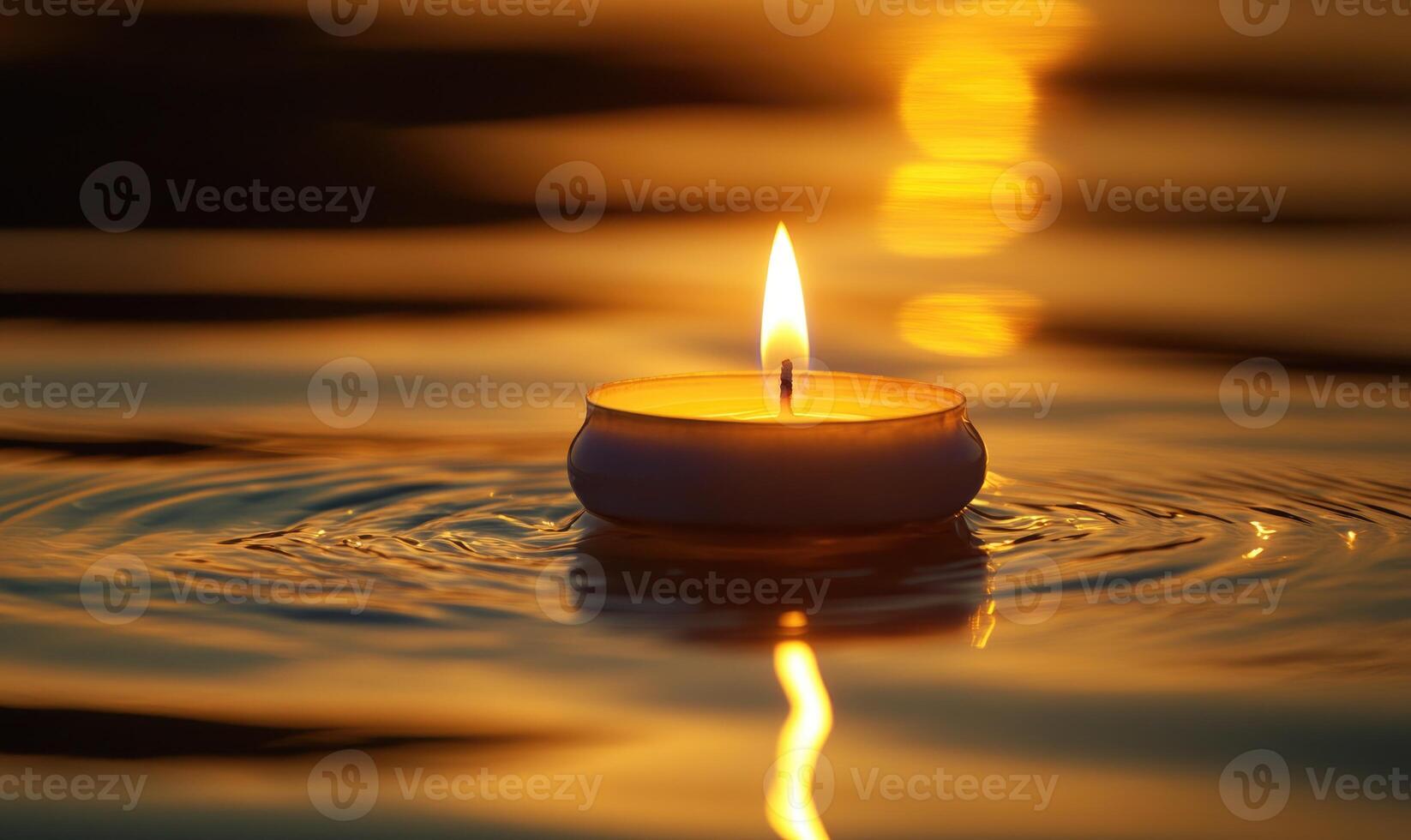 Single floating candle on rippling water, soft golden glow illuminating the scene photo