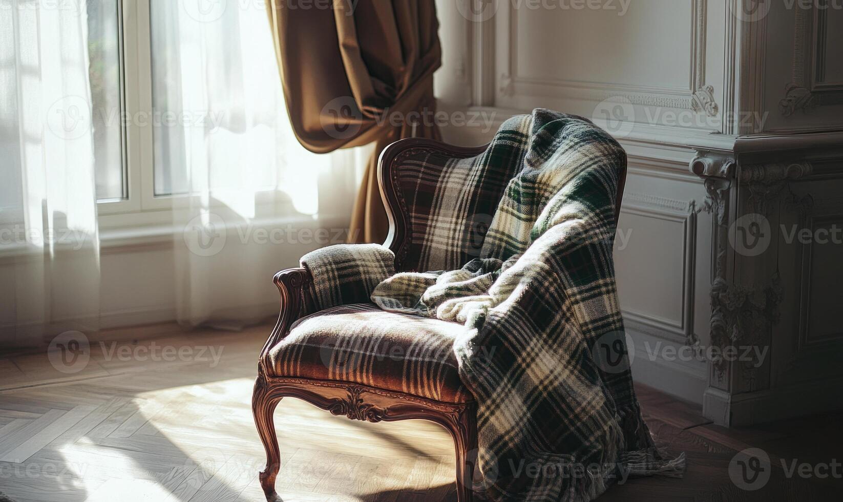 A chair with a blanket draped over it sits in a room with a window photo