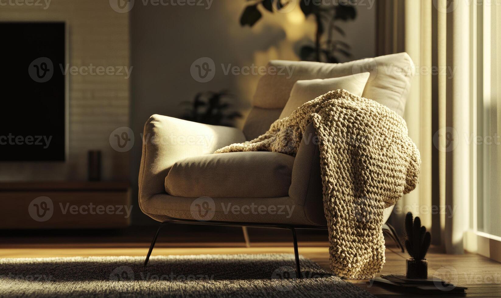 A white chair with a blanket draped over it sits in a living room photo