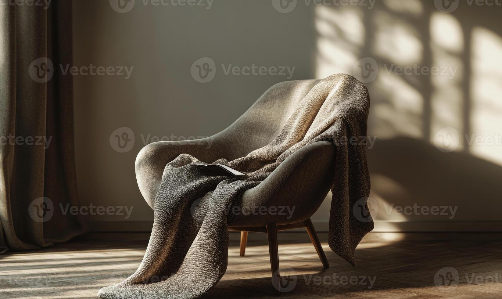 A chair with a blanket draped over it sits in a room with a window photo