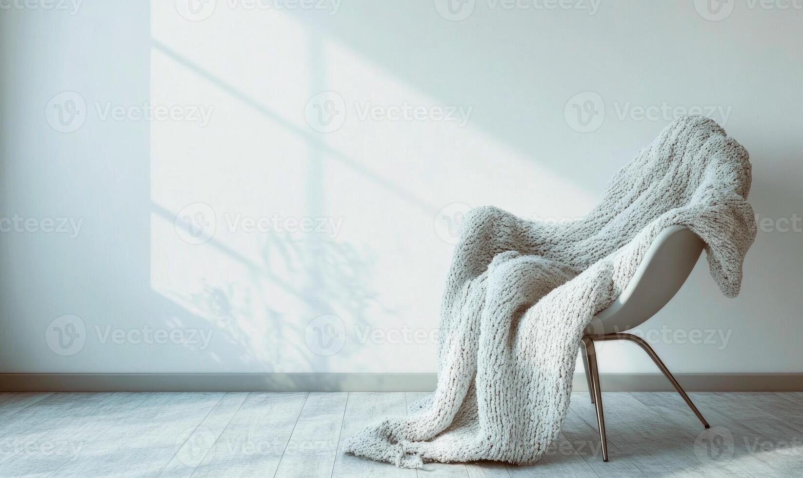 A white chair with a white blanket draped over it photo