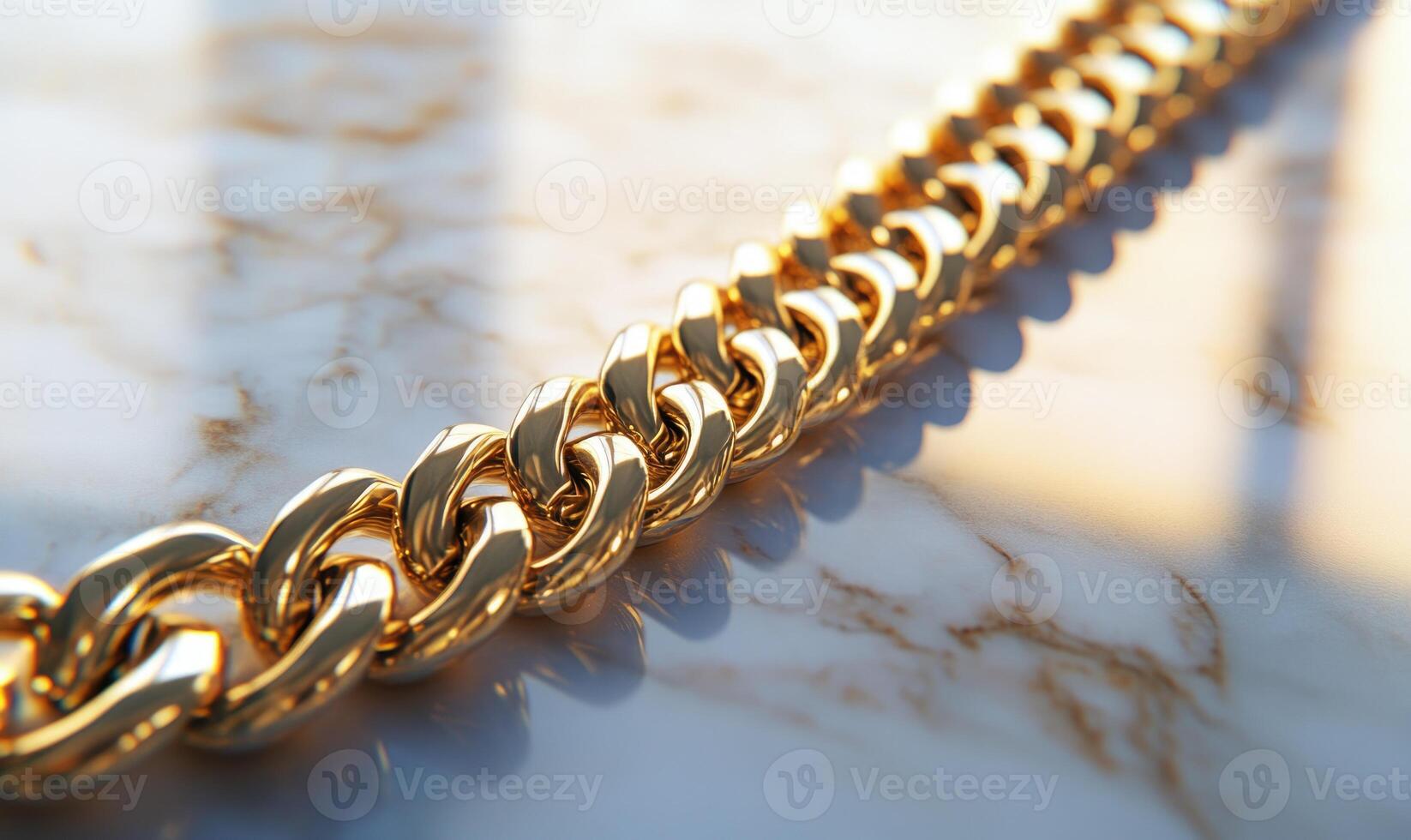 A gold chain with a gold clasp is displayed on a marble countertop photo