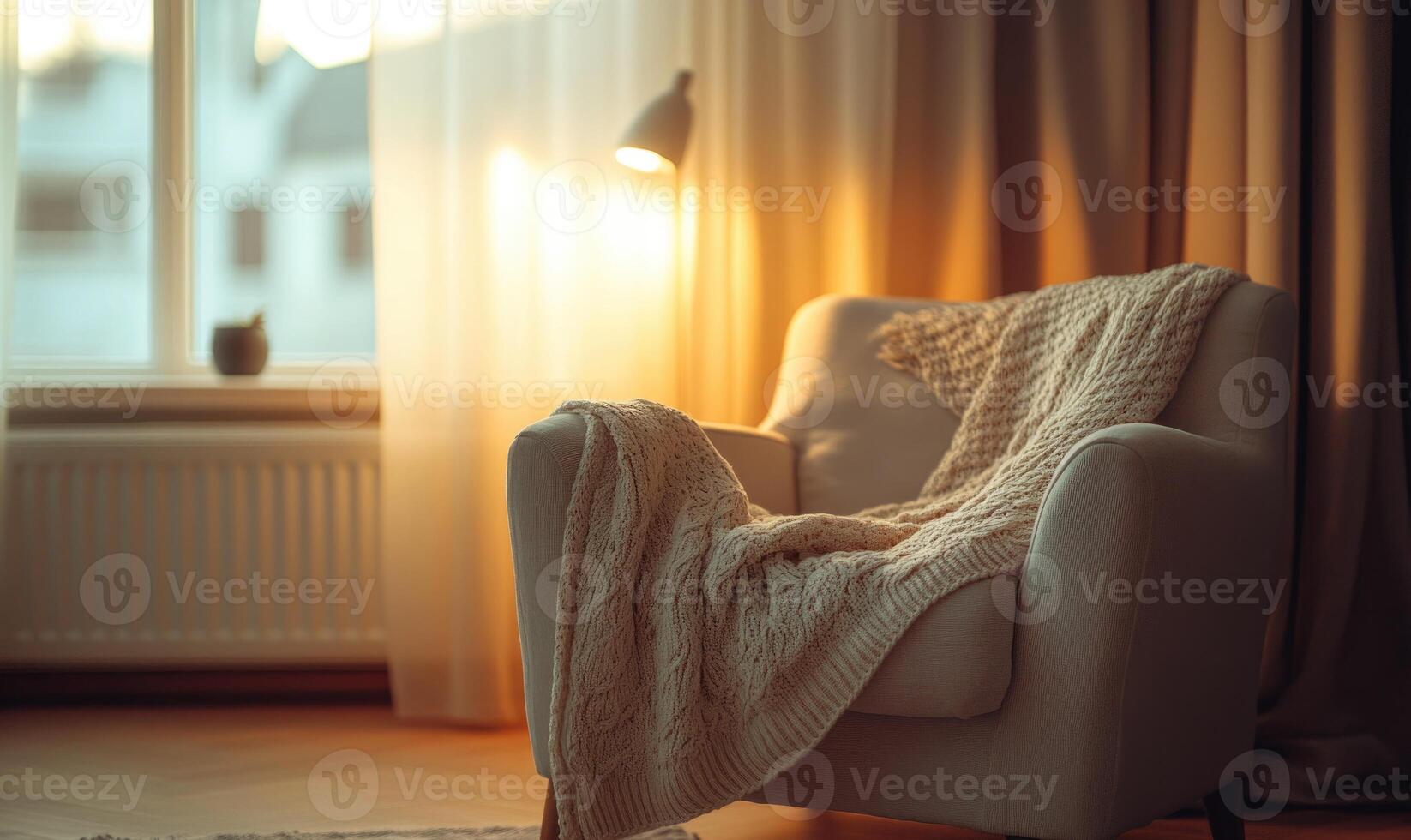 A chair with a white blanket draped over it sits in front of a window photo