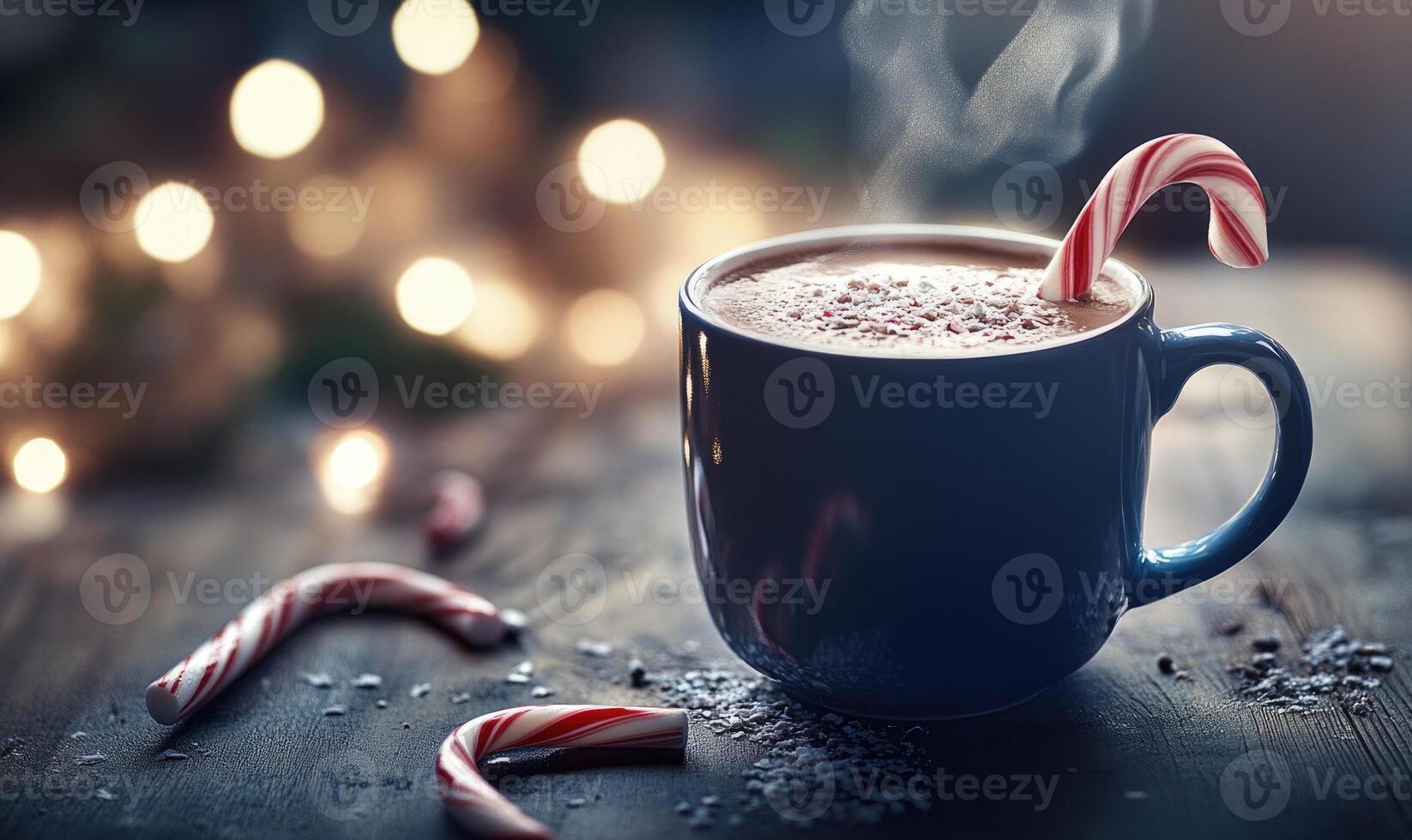 A mug of hot chocolate with a few red and white candy cane stirrers in it photo