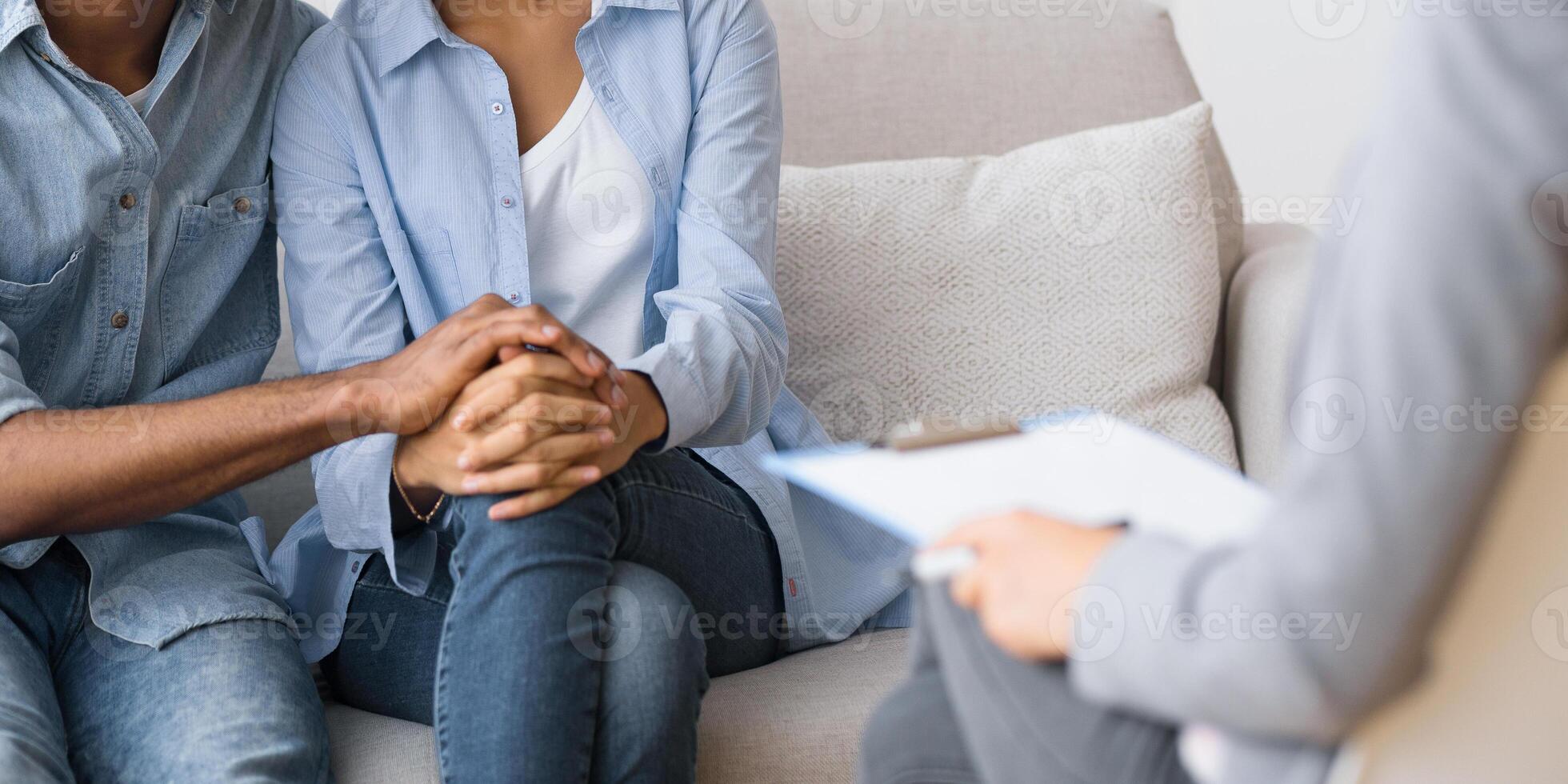 Relationship Coaching. Lovely African American Spouses Hugging After Reconciling On Marital Counseling At Psychologist's Office. Selective Focus photo
