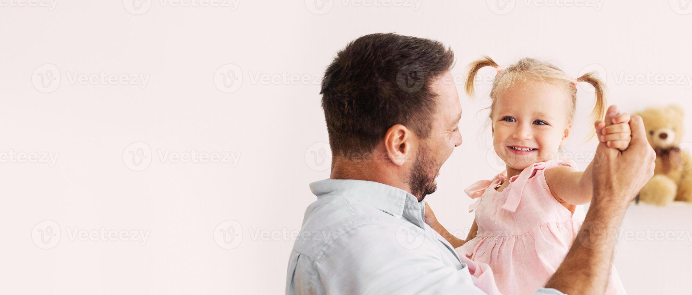 Family Concept. Portrait of adorable little girl dancing with her cheerful dad. Free space, panorama photo